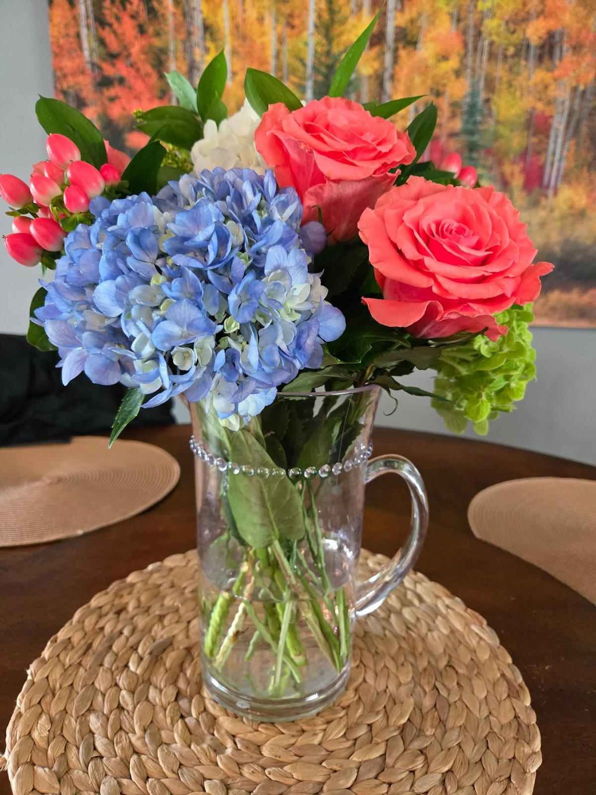 Flowers in a glass pitcher, the Everwillow studio in the background